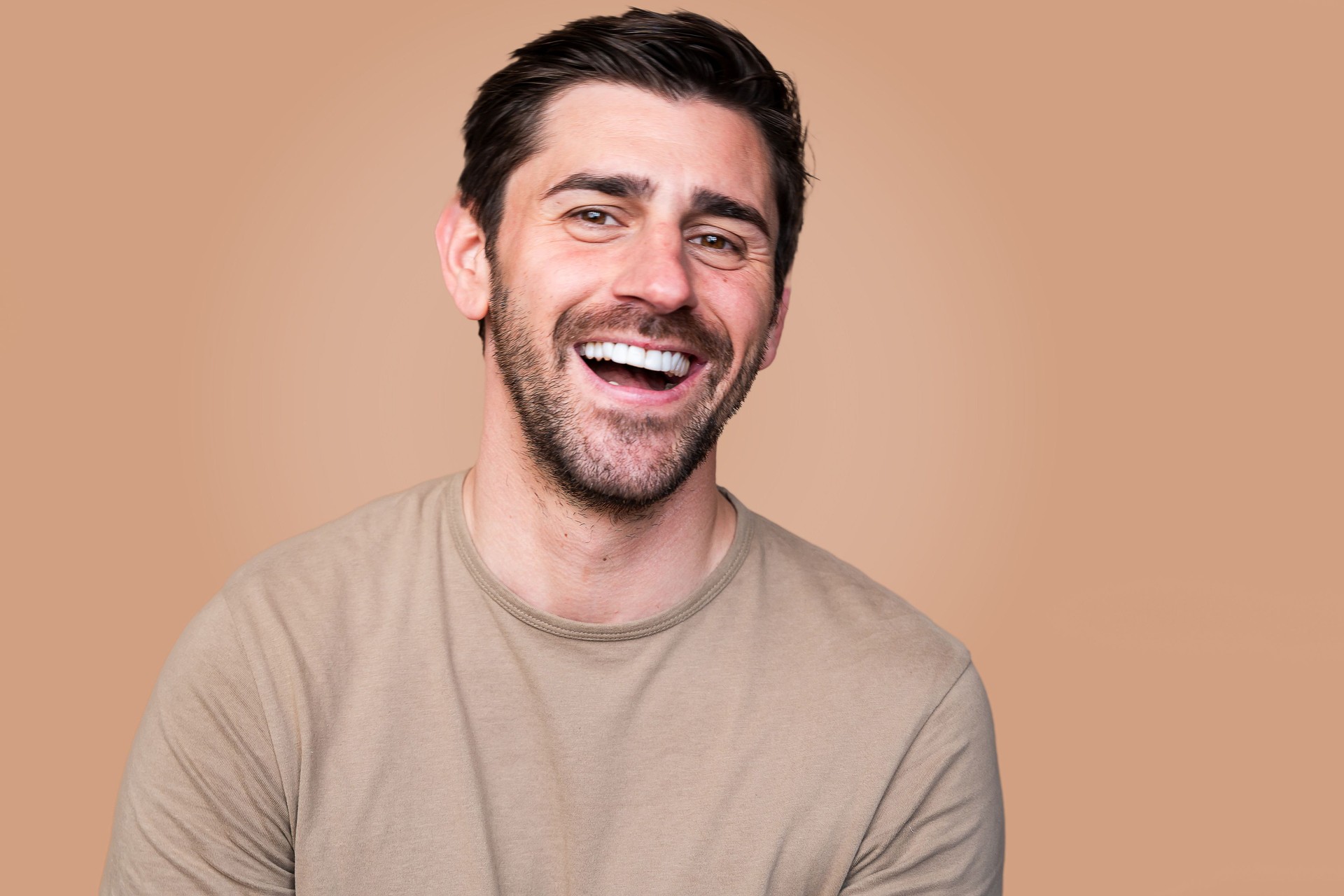 Smiling man with brown background