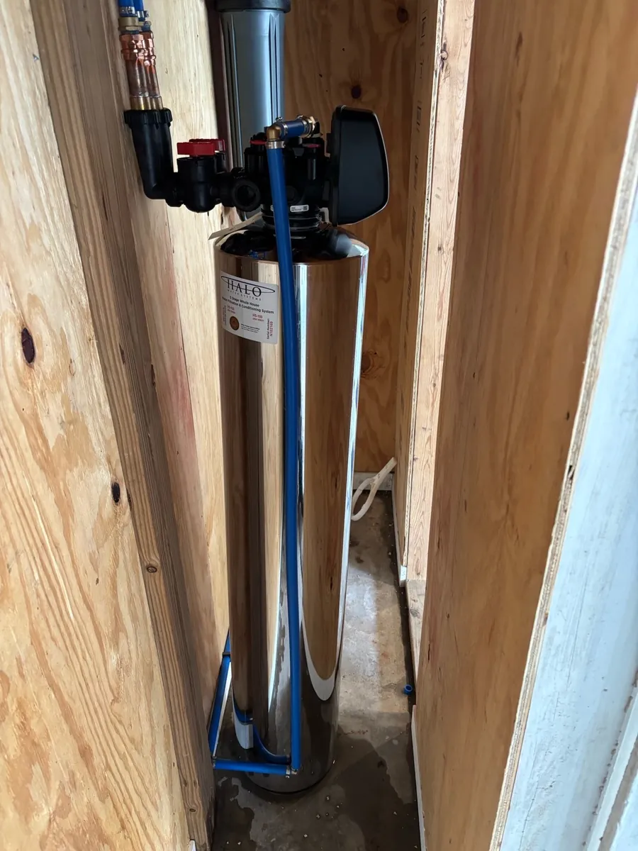 A stainless HALO treatment tank stands inside a timber wall bay.